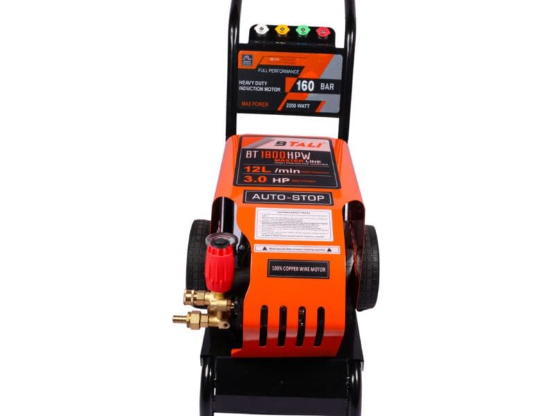 A professional technician using a high pressure cleaner and solar panel pressure washer to clean solar panels in India.