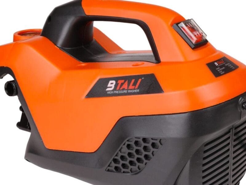 Industrial heavy duty pressure washer cleaning construction equipment using Btali International high pressure cleaner in India.